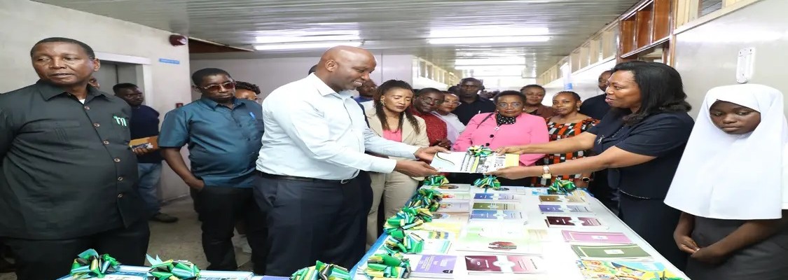The Deputy Chairperson of the Parliamentary Committee on Education, Culture and Sports, Hon. Mussa Ramadhani Sima (MP), receiving the National Literac...