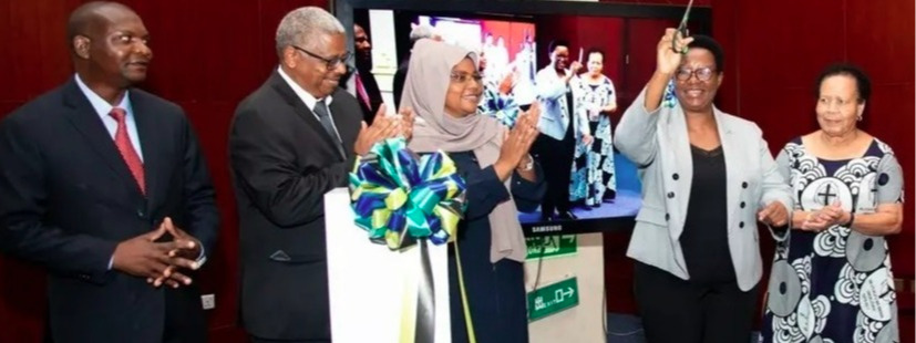 The Permanent Secretary, Ministry of Education, Science, and Technology, Prof. Carolyne Nombo, cutting the ribbon to mark launch of the IPOSA document...